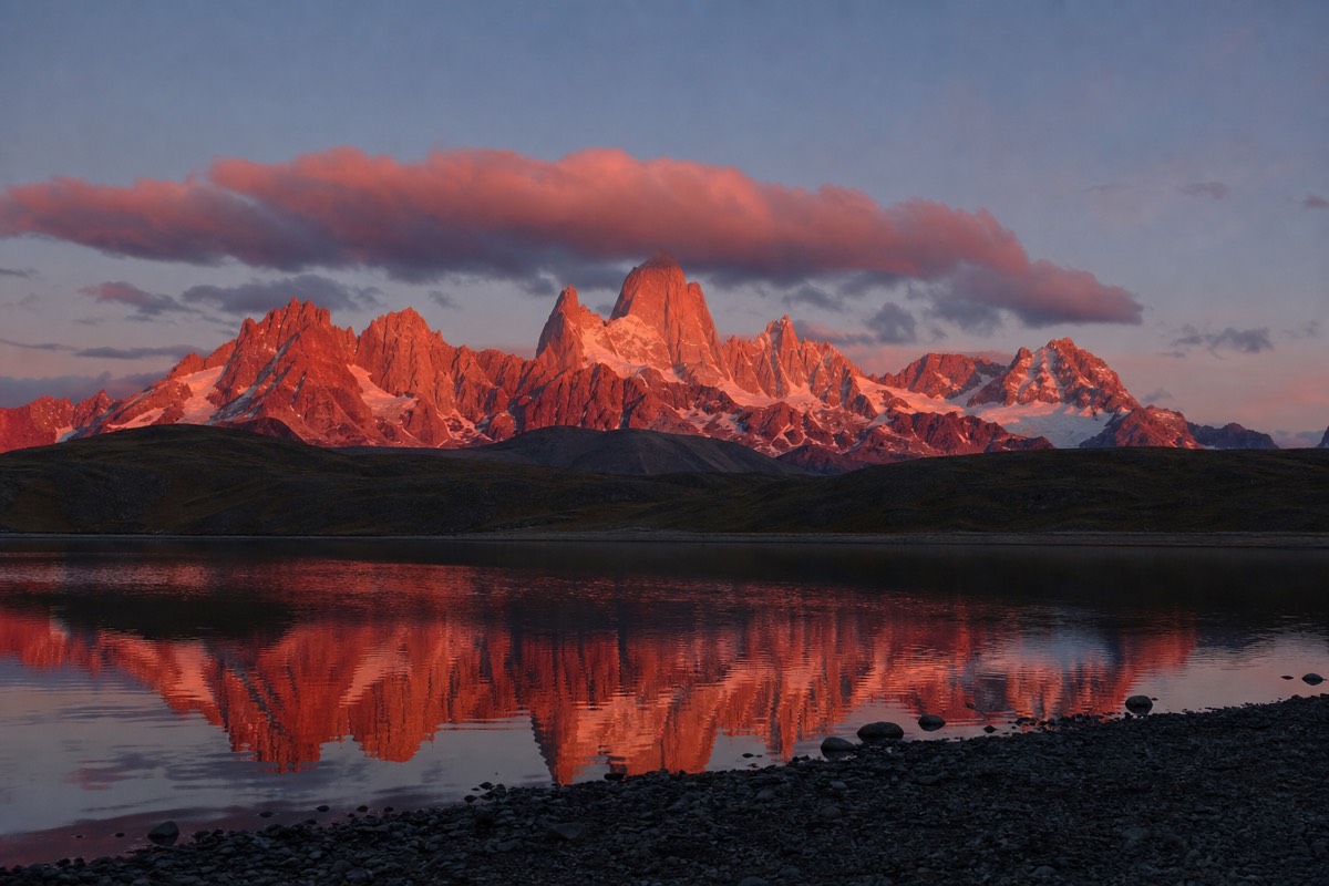 Evening alpenglow lighting the Cuernos del Paine above a still lake