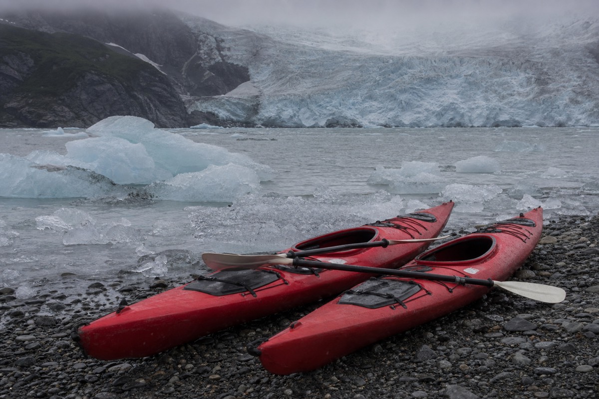 Kayaks on the shore of Lago Grey among floating ice